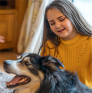 Photo of Girl Holding her Dog