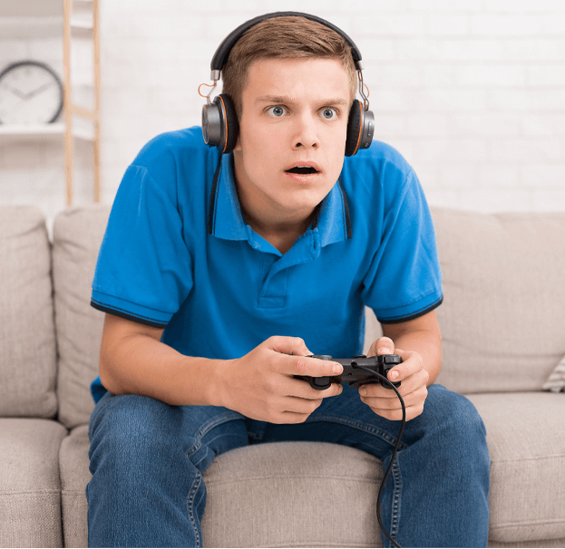 Boy Playing Game Surprised at What He Hears 